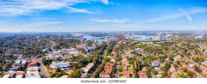 Cityscape Of Sydney City Skyline Over Western Sydney City Of Ryde Suburbs On Shores Of Parramatta River - Aerial Landscape.