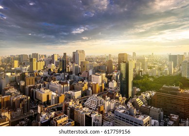 Cityscape Of Tokyo, City Aerial Skyscraper View Of Office Building And Downtown And Street Of  Minato In Tokyo With Sunset / Sun Rise Background With Yellow Sunlight Effect. Tokyo, Japan, Asia