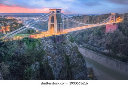 Cityscape view of Bristol, England, UK and the Clifton Suspension Bridge above the Avon Gorge and River Avon at sunset or sunrise from St Vincent's  Rocks.