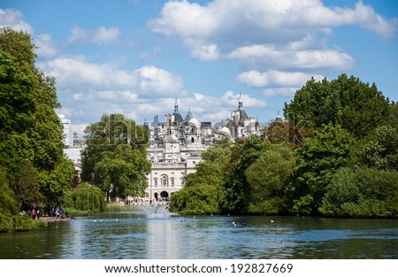 A cityscape view through the Serpentine lake in Hyde Park, Kensington Gardens in sunny day. London UK.