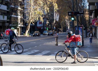 CIUDAD AUTONOMA DE BUENOS AIRES, ARGENTINA - Jun 08, 2021: The Santa Fe Avenue With Two Food Delivery People On Bicycles In Buenos Aires, Argentina