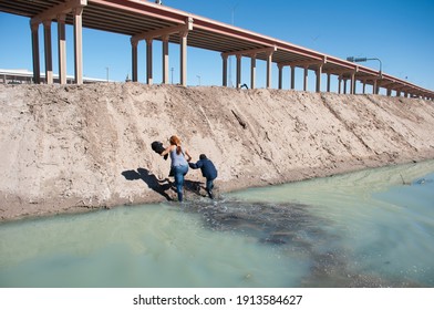 Ciudad Juárez, Chihuahua, 02-08-2021 Mexico A Central American Woman And Her Son Cross The Rio Grande To Surrender To The Border Patrol At The Texas United States Crossing, Moments Later Another Famil