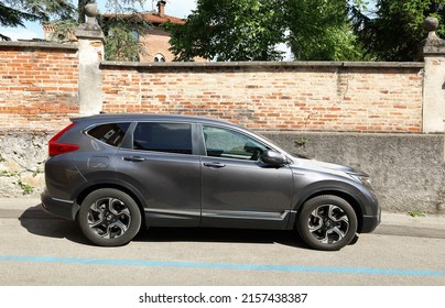 Cividale, Italy. May 17, 2022. Gray Honda CR V  Hybrid Parked At The Roadside. Side View With Brick And Concrete Wall On Background.