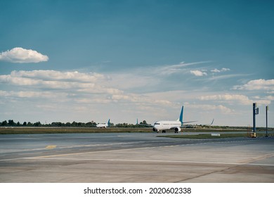 Civil airplanes parked on the runway in the morning