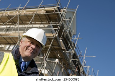 Civil Engineer With Construction Site In Background.