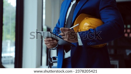 Civil Engineer Hispanic smiling with Constuction backgrounds, use for banner cover. Success in target of project goal Handsome Middle Eastern worker.
