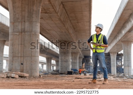 A civil engineer is inspecting a road or expressway construction project under a road under construction.