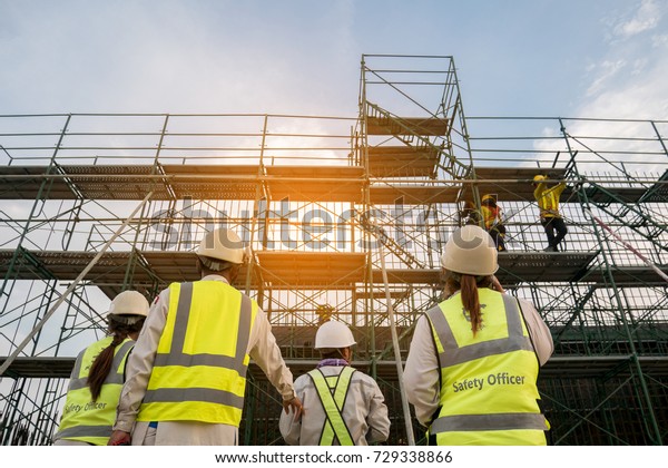 Civil\
engineer and safety officer in spec steel truss structure\
scaffolding risk analysis in construction site\
