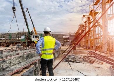 Civil Engineer supervised the construction of a tower crane and pile of concrete on construction sites in operation.
 - Shutterstock ID 1167135487
