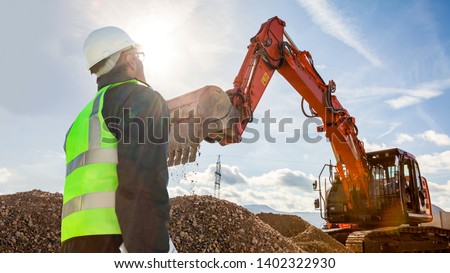 civil engineer worker on consstruction site with excavator machine