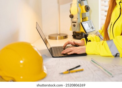 Civil Engineer Working Diligently on Laptop at Construction Site During Bright Daylight Hours