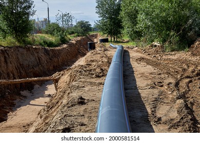 Civil engineering. Plastic water pipe lies next to the trench for installation.