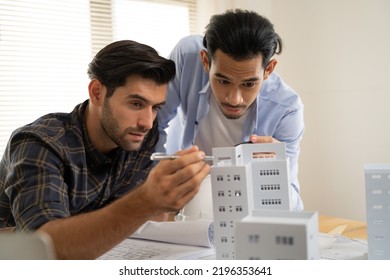 Civil Engineers And Architect Inspector Discussing Brainstorm Meeting Inspect, Audit And Advice About House Building Or Real Estate Project With Prototype Model