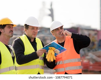 Civil engineers and construction workers at work on construction site