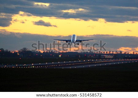 Civil passenger airplane departing in dawn.