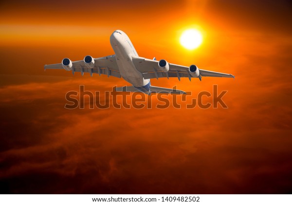 Civil wide body plane in flight. Aircraft flying on\
a high altitude over the clouds during flaming sunset. Airplane\
front view.