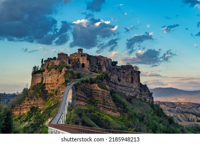 Civita di Bagnoregio, ancient medieval village in central Italy with dramatic sky at sunset. Now a major touristic attraction.