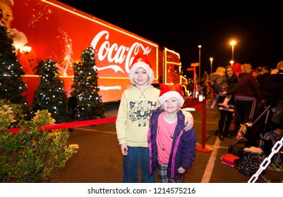 Clacton On Sea, Essex - 20th December 2017 - A Brother And Sister Pose With The World Famous Coca Cola, CocaCola Christmas Truck, Lorry On View For All To See