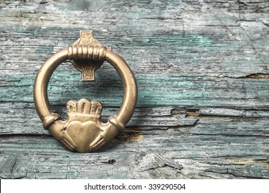 Claddagh, irish symbol of love, friendship and loyalty in old wooden background