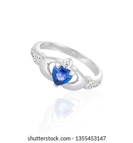 Claddagh ring with blue topaz isolated on white. Traditional Irish ring in shape of two hands holding a heart shaped blue gemstone which represents love, loyalty, and friendship