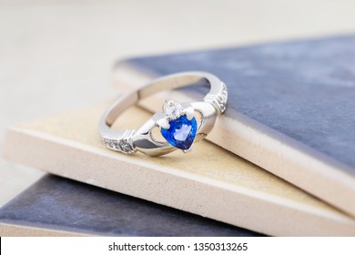 Claddagh ring with blue topaz. Traditional Irish ring in shape of two hands holding a heart shaped blue gemstone which represents love, loyalty, and friendship