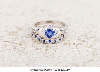 Claddagh ring with blue topaz. Traditional Irish ring in shape of two hands holding a heart shaped blue gemstone which represents love, loyalty, and friendship