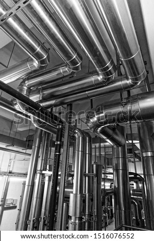 Cladded pipework in plant room 
