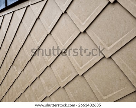 cladding of a building with expanded metal lattice structure. galvanized gray nets protect the industrial building. contrast to a silver background, wall, corner, slanted, sheet metal, cladding, lined