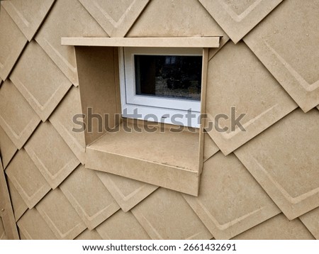 cladding of a building with expanded metal lattice structure. galvanized gray nets protect the industrial building. contrast to a silver background, wall, corner, slanted, sheet metal, cladding, lined