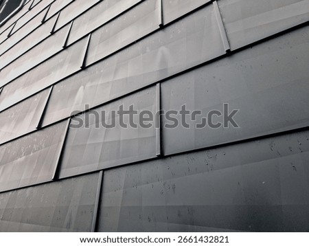 cladding of a building with expanded metal lattice structure. galvanized gray nets protect the industrial building. contrast to a silver background, wall, corner, slanted, sheet metal, cladding, lined