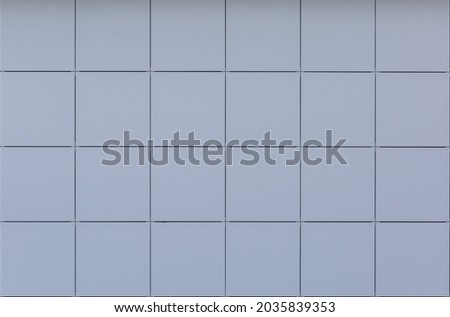 Cladding (facing) with square metal facade panels with fastening elements. High quality texture 
