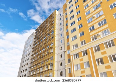 Cladding and warming wall of monolithic house under construction. Insulating wall facade of residential building.
Thermal insulation works. Fcade of a apartment building with mineral wool plates.