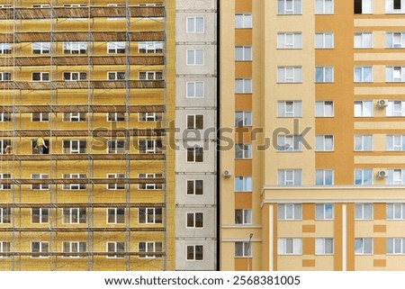 Cladding and warming wall of monolithic house under construction. Insulating wall facade of residential building.
Thermal insulation works. Fcade of a apartment building with mineral wool plates.
