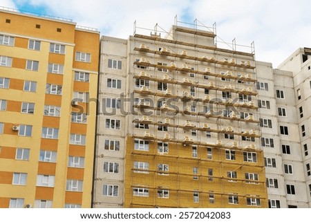 Cladding and warming wall of monolithic house under construction. Insulating wall facade of residential building.
Thermal insulation works. Facade of a apartment building with mineral wool plates