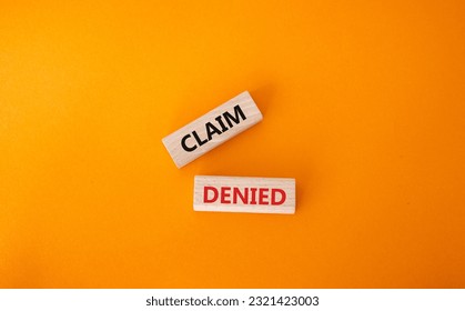 Claim denied symbol. Wooden blocks with words Claim denied. Beautiful orange background. Business and Claim denied concept. Copy space. - Shutterstock ID 2321423003