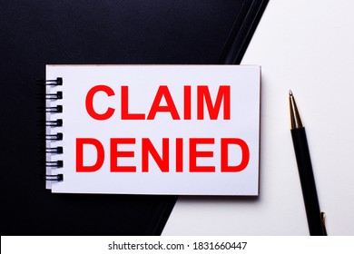 CLAIM DENIED written in red on a black and white background near the pen - Shutterstock ID 1831660447
