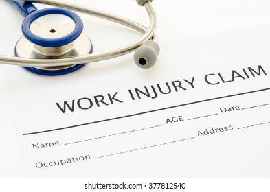 Claim form for an injury at work with stethoscope.