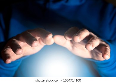 Clairvoyance, Foresight, Extrasensory Perception, And Paranormal Abilities. Men's Hands Over White Magic Light