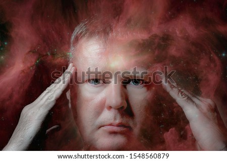Clairvoyance, foresight, extrasensory perception, and paranormal abilities. Portrait of a man with bright yellow eyes. Elements of this image furnished by NASA