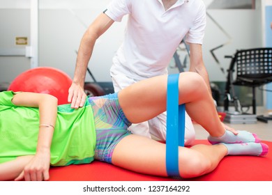 Clam. Exercise For Hip Extra-rotatory Muscles. Physiotherapist Towards An Athlete.