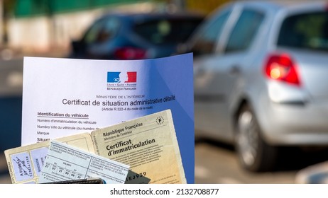 Clamart, France - March 6, 2022: French vehicles administrative documents : Registration certificate ("Carte grise"), insurance card and certificate of administrative status ("Certificat de non-gage")