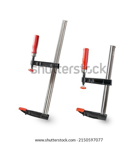 
Clamp.Red and black clamp.Iron clamps.Clamps and vise close-up.The reliable tool for performance of assembly, joiner's and metalwork works.F-shaped design.Tool in the workshop.Engineering tool