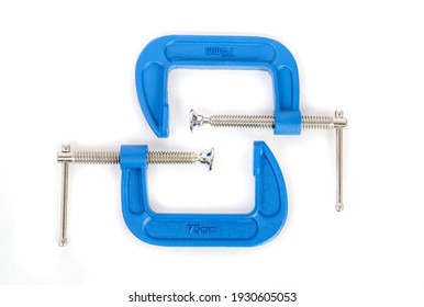 Clamp - professional tool for clamping objects isolated on a white background.