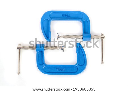 Clamp - professional tool for clamping objects isolated on a white background.
