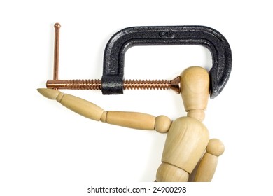 A clamp squeezing tightly on the head of a wooden man.  A great concept shot for headaches or stress.