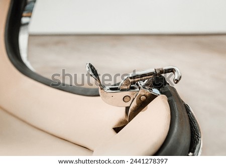 Clamp and toggle hook on detachable hardtop of vintage sports car. Close up. Muscle car or luxury collector car parts. Selective focus on clamp.