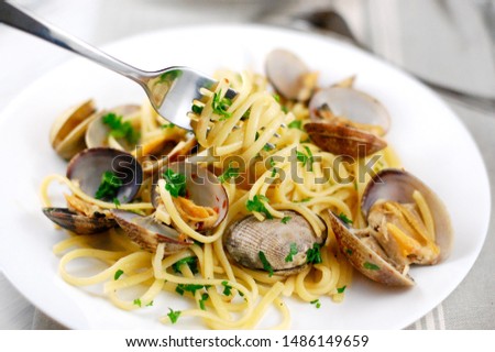 Clams with pasta for dinner, lunch, seafood day, cooking with clams, Italian dish, spaghetti with clams cooked in white wine