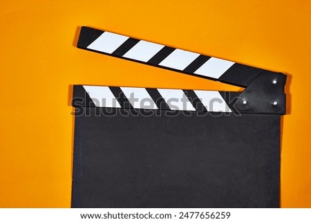 clapper board of video cinema in studio. Movie production clapper board on orange background