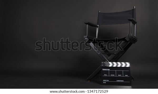 Clapperboard or\
movie slate with director chair use in video production or movie\
and cinema industry. It\'s black\
color.