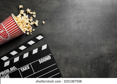 Clapperboard And Popcorn On Table